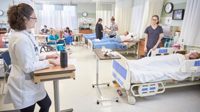 Nursing students work in simulated hospital classroom