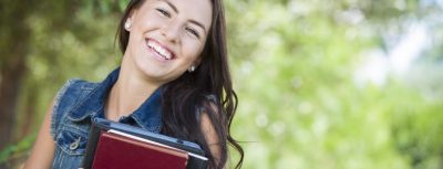 smiling student holding books