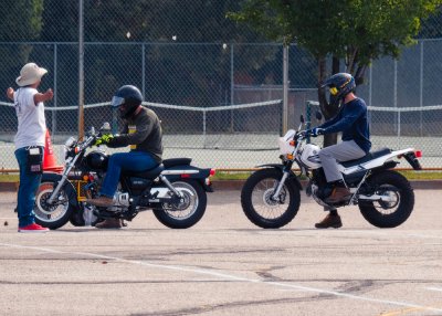 Two motorcyclist and instructor at safety class