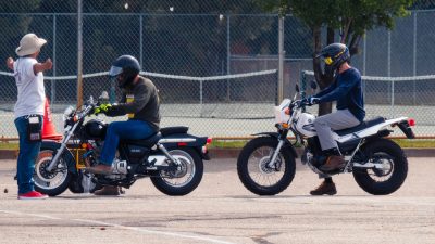 Two motorcyclist and instructor at safety class