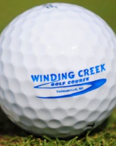 Golf ball with Winding Creek Golf Course printed on it