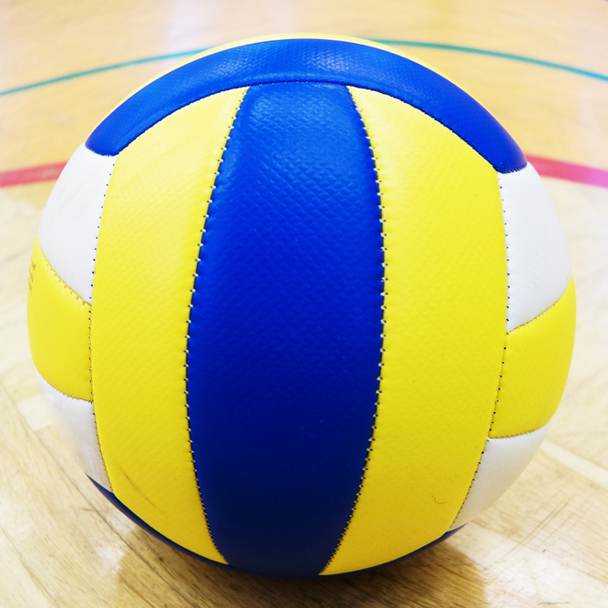 Blue and yellow volleyball on court