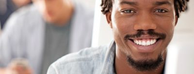 African American student with facial hair smile at camera
