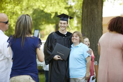 New DCCC graduate poses for a picture with family member
