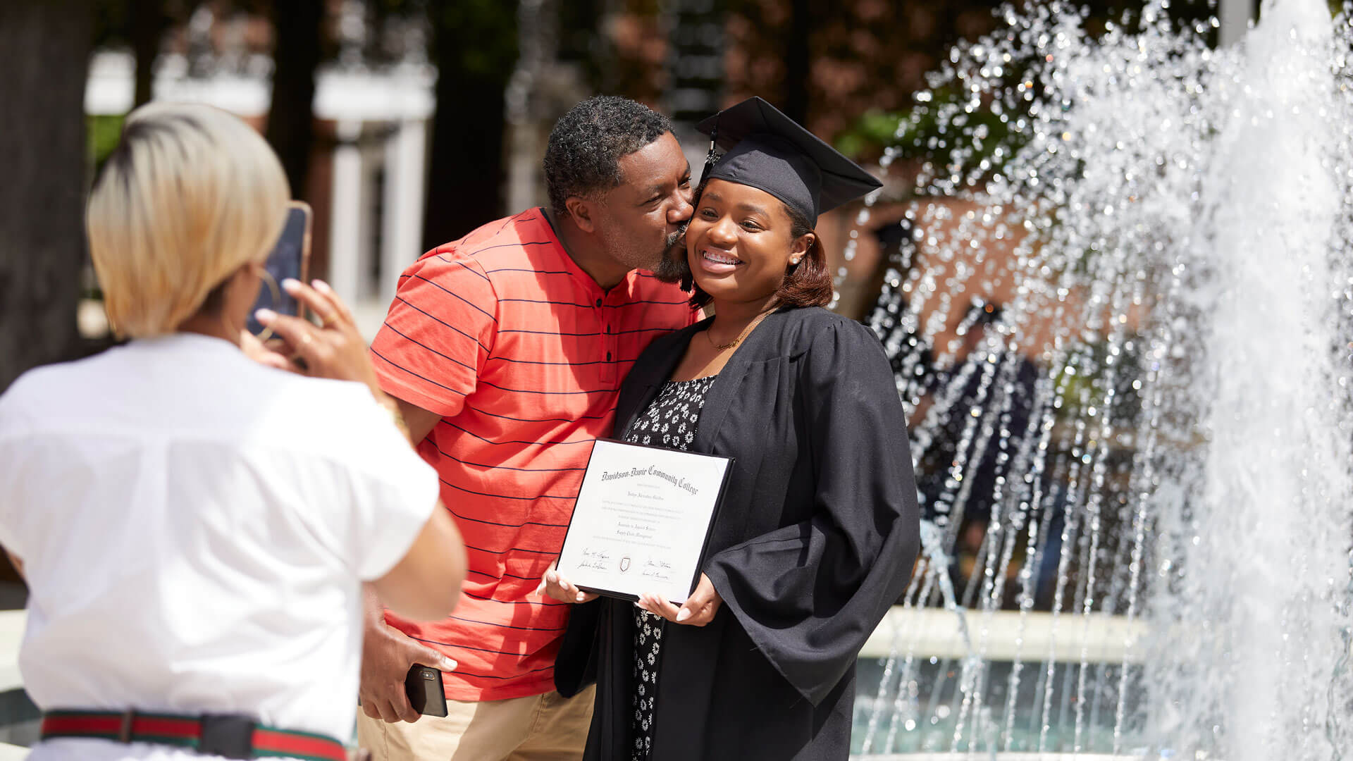 Parents congratulate recent graduate