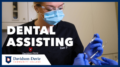 Dental Student with mask and dental tools. Text Reads: "Dental Assisting"