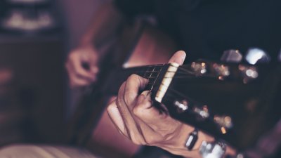 closeup of person holding guitar