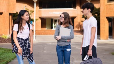 Three students standing in Davidson-Davie courtyard