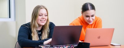Two Students in front of laptops