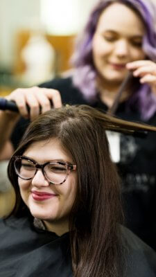 Cosmetology students practice on hair