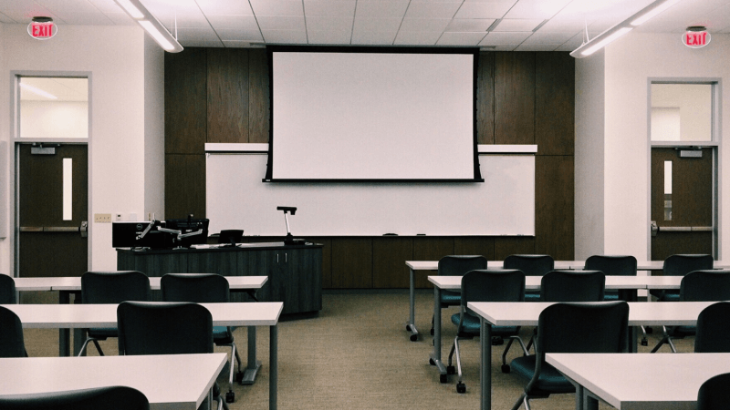 Empty classroom with projector screen