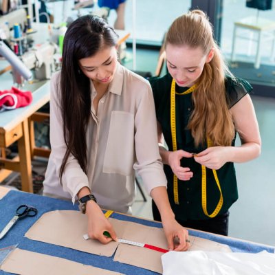 high school aged students measure sewing patterns