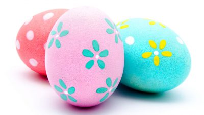 Three colorful handmade easter eggs isolated on a white background