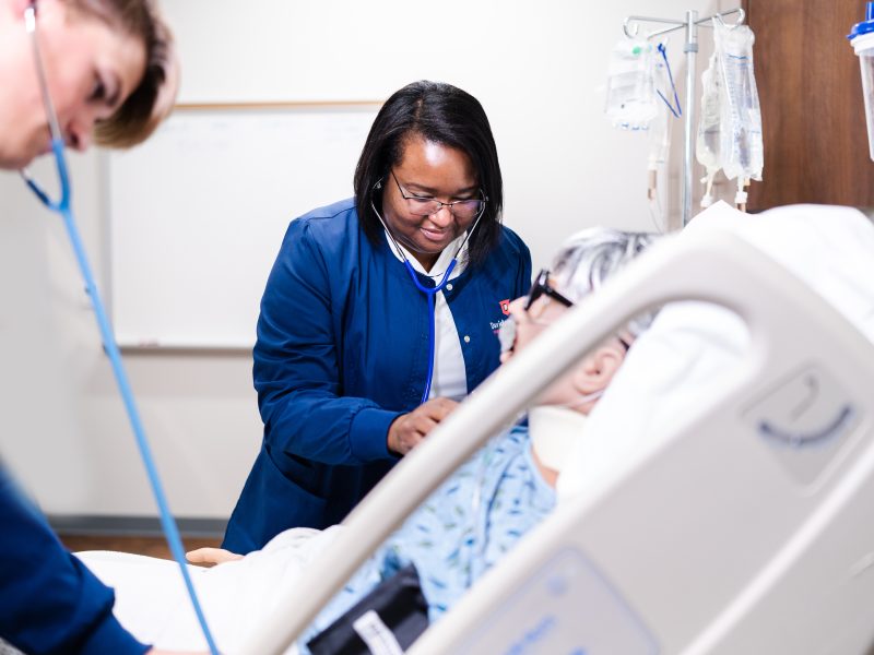 Davidson-Students check vitals on computerized patient simulator