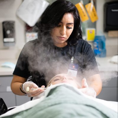 Esthetics student uses steam to perform procedure on patient