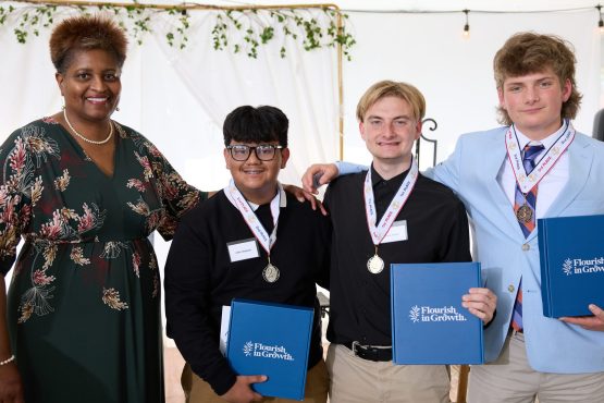From left to right are Dr. Dee Stokes, director of the Small Business Center at Davidson-Davie Community College, with YES winners John Vasquez (second place), Davis Norton (first place), and Caswell Moore (third place).
