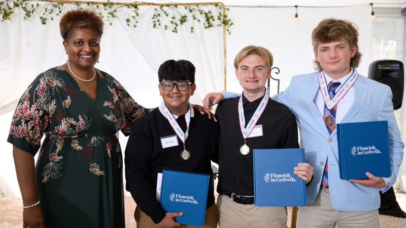From left to right are Dr. Dee Stokes, director of the Small Business Center at Davidson-Davie Community College, with YES winners John Vasquez (second place), Davis Norton (first place), and Caswell Moore (third place).