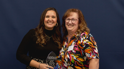 Ashley Bonnett from Home Star Realty holds award.