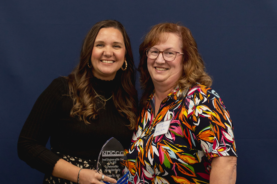 Ashley Bonnett from Home Star Realty holds award.