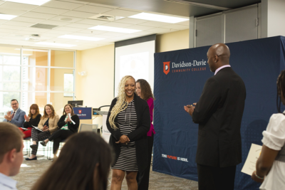 A woman is applauded at an indoor event at Davidson-Davie Community College.